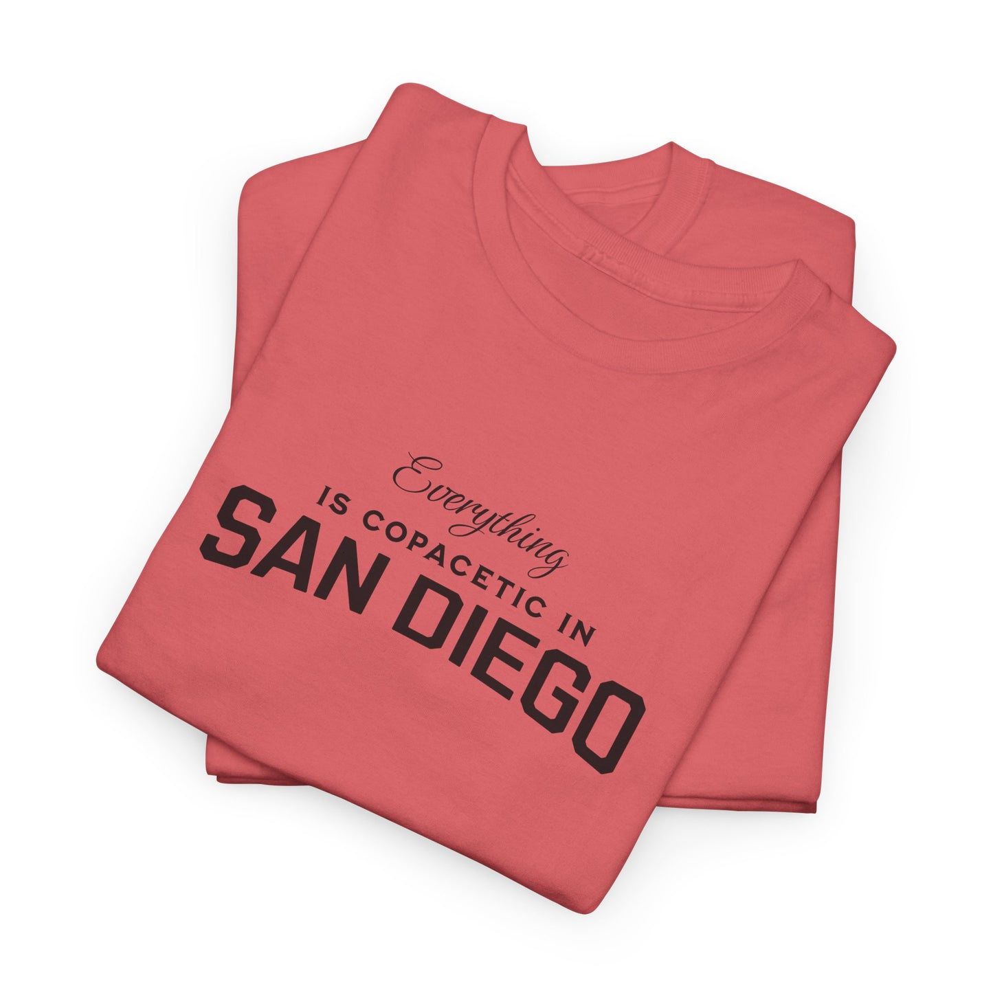 Folded red t-shirt with 'Everything is copacetic in San Diego' text on a white background
