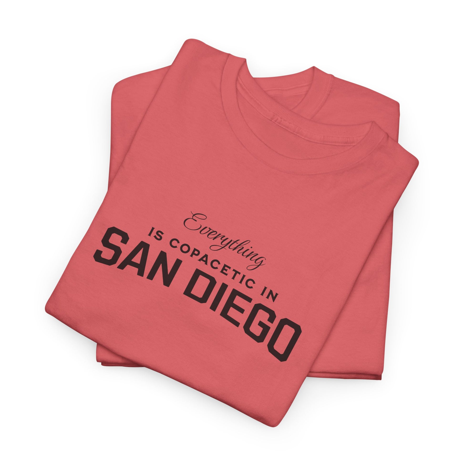 Folded red t-shirt with 'Everything is copacetic in San Diego' text on a white background